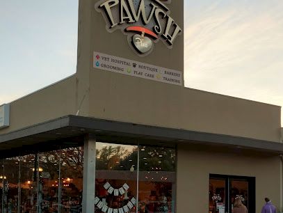 A store named "Pawsh" with large signage featuring a paw print and slogan related to pet supplies and grooming services.